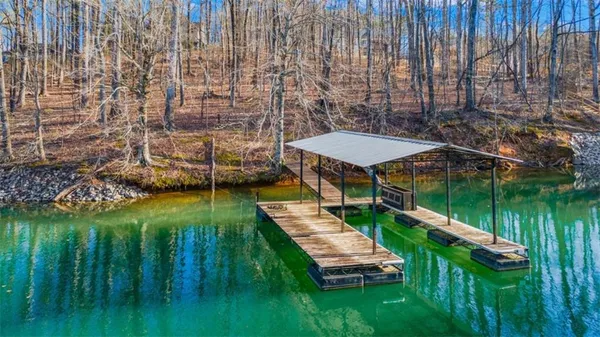 a view of a lake with a yard table and chairs