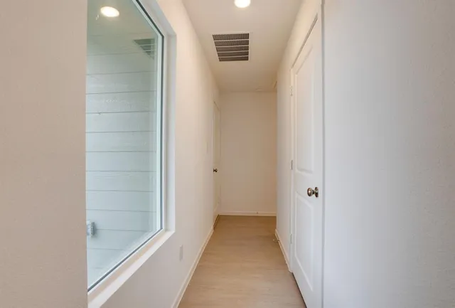 a view of a bathroom from a hallway