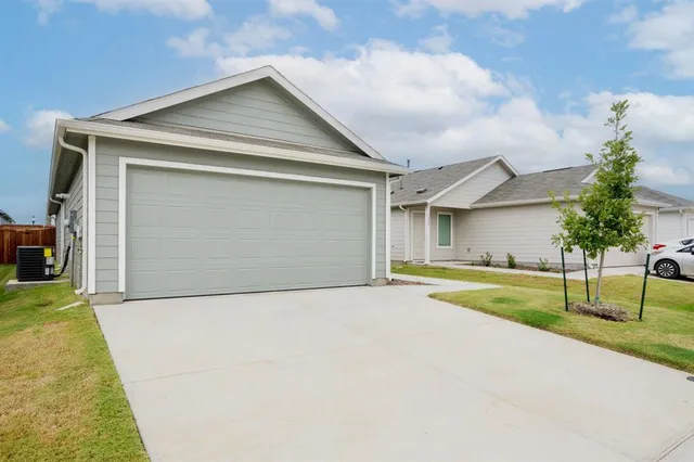 a view of an house with backyard and parking