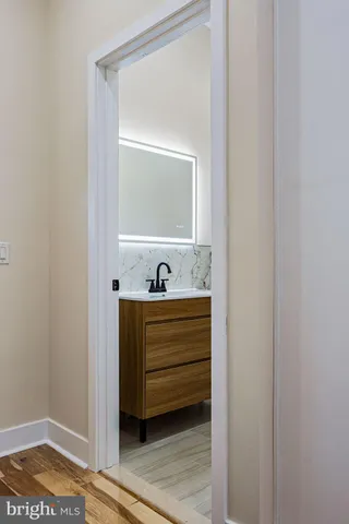 a bathroom with a sink toilet a mirror and shower