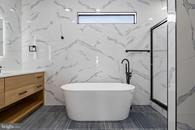 a bathroom with a bathtub and a double vanity sink