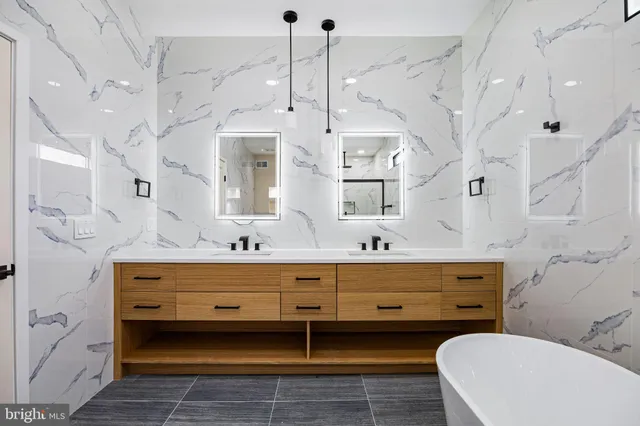 a bathroom with a granite countertop toilet sink and shower
