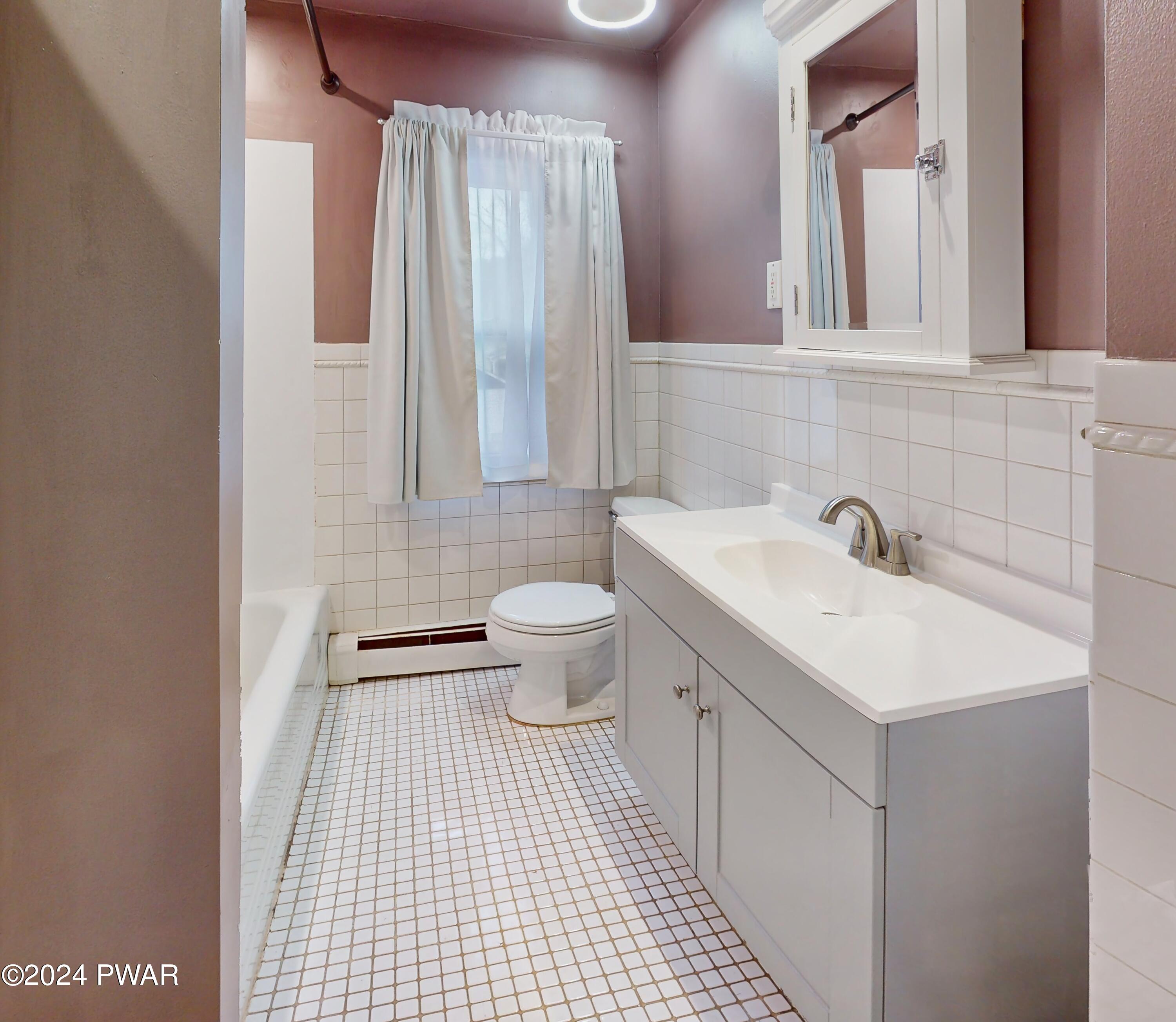 108 9th Street Milford, PA 18337 - Photo 20 of 38 a bathroom with a sink and a mirror