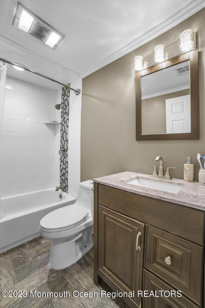 47 Forest Drive Jackson, NJ 08527 - Photo 11 of 17 a bathroom with a granite countertop sink toilet mirror vanity and bathtub