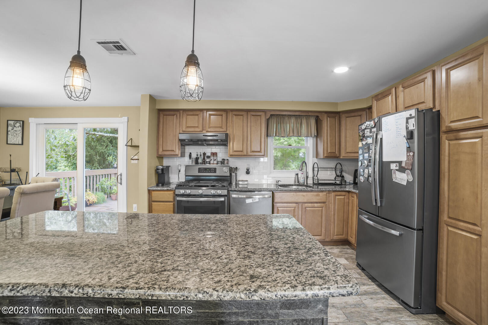 47 Forest Drive Jackson, NJ 08527 - Photo 4 of 17 a kitchen with stainless steel appliances granite countertop a refrigerator a stove a sink a refrigerator a stove a dining table and chairs with wooden floor