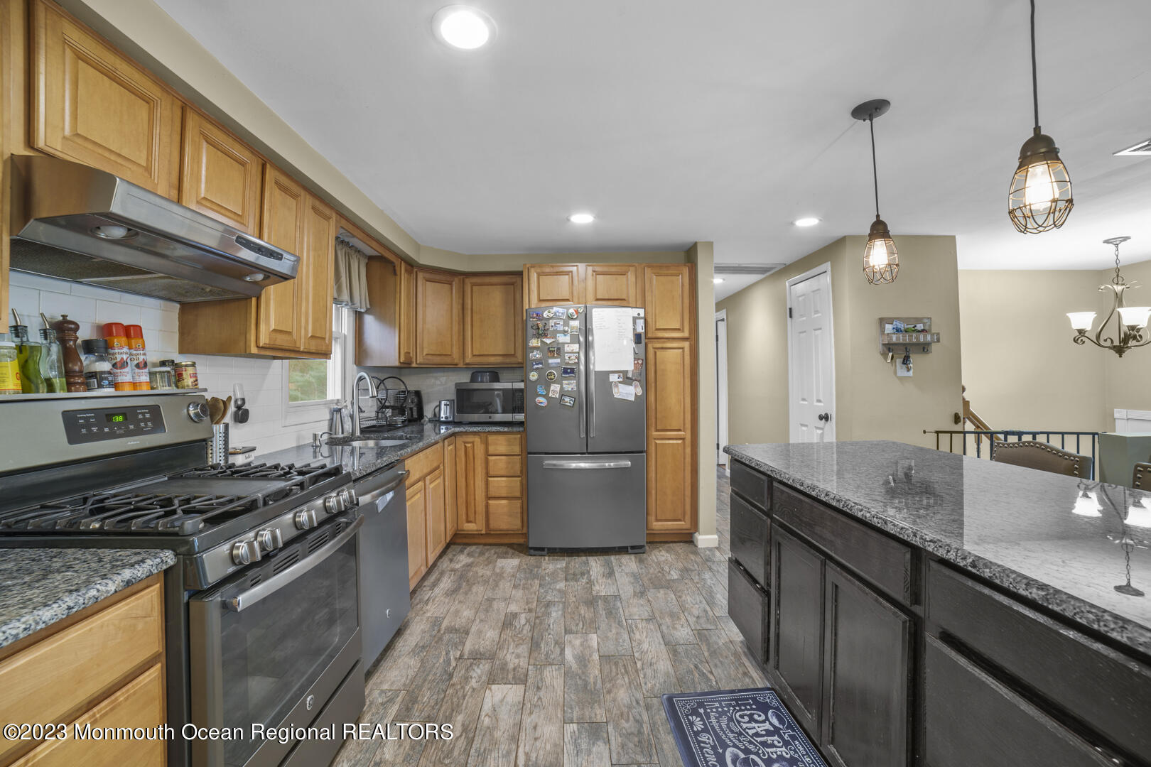 47 Forest Drive Jackson, NJ 08527 - Photo 5 of 17 a kitchen with stainless steel appliances granite countertop a sink a stove and a wooden floors
