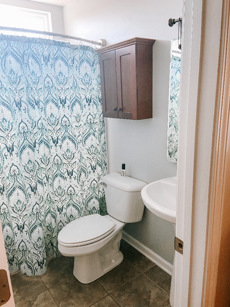 827 Oslo Road Mount Juliet, TN 37122 - Photo 15 of 25 a white toilet sitting next to a shower curtain
