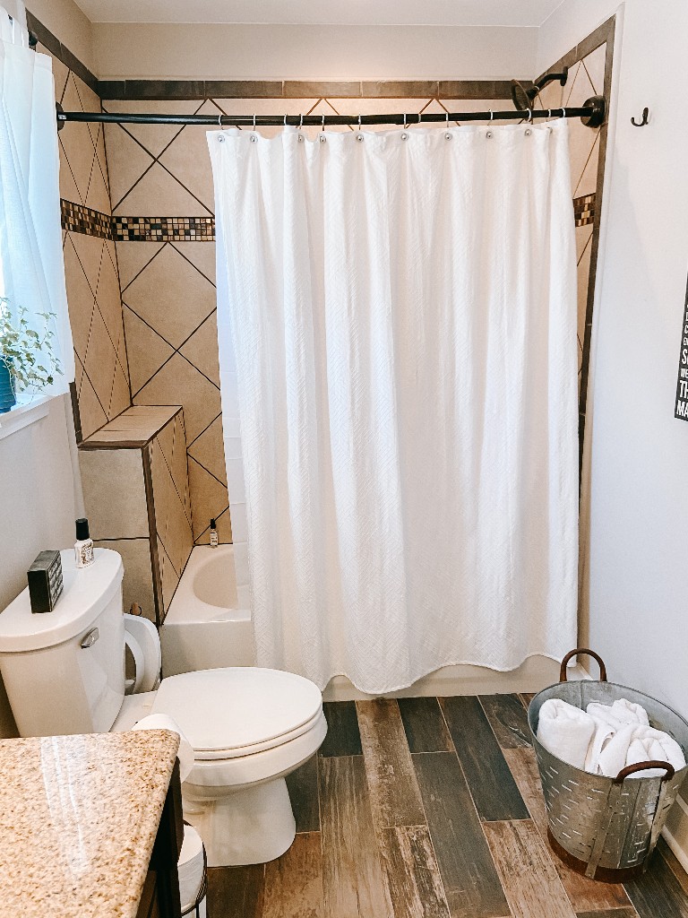 827 Oslo Road Mount Juliet, TN 37122 - Photo 19 of 25 a bathroom with a toilet and a shower curtain