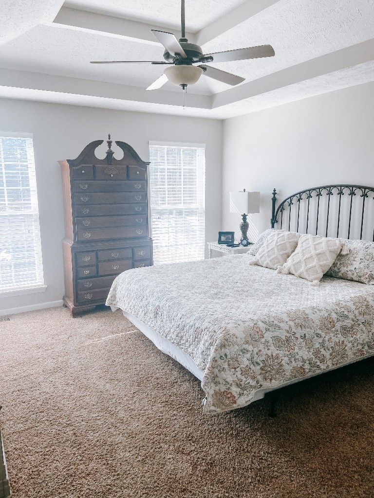 827 Oslo Road Mount Juliet, TN 37122 - Photo 10 of 25 a bedroom with a bed a chandelier and a fireplace