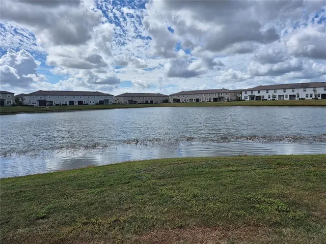 a view of a lake with houses in the back