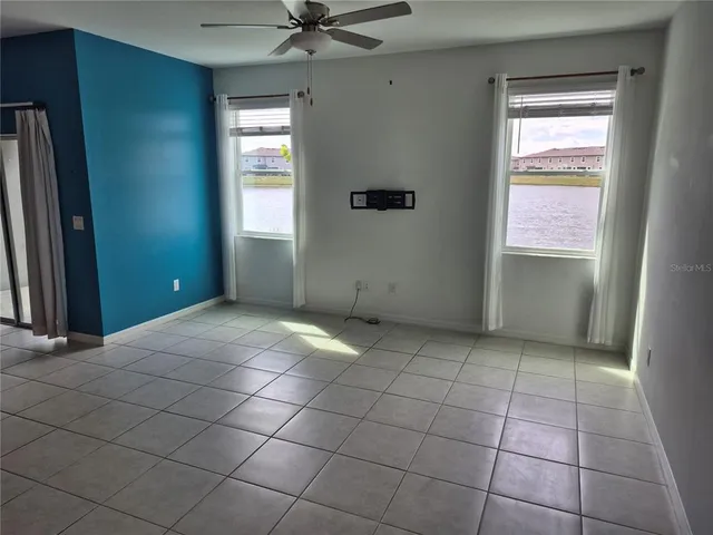 an empty room with windows and closet