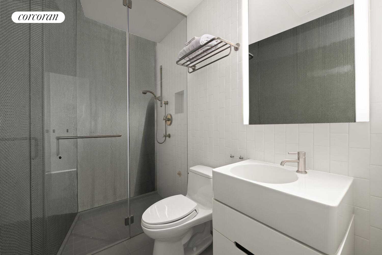 56 West 71st Street, Unit 2A Manhattan, NY 10023 - Photo 12 of 17 a bathroom with a sink a toilet and shower