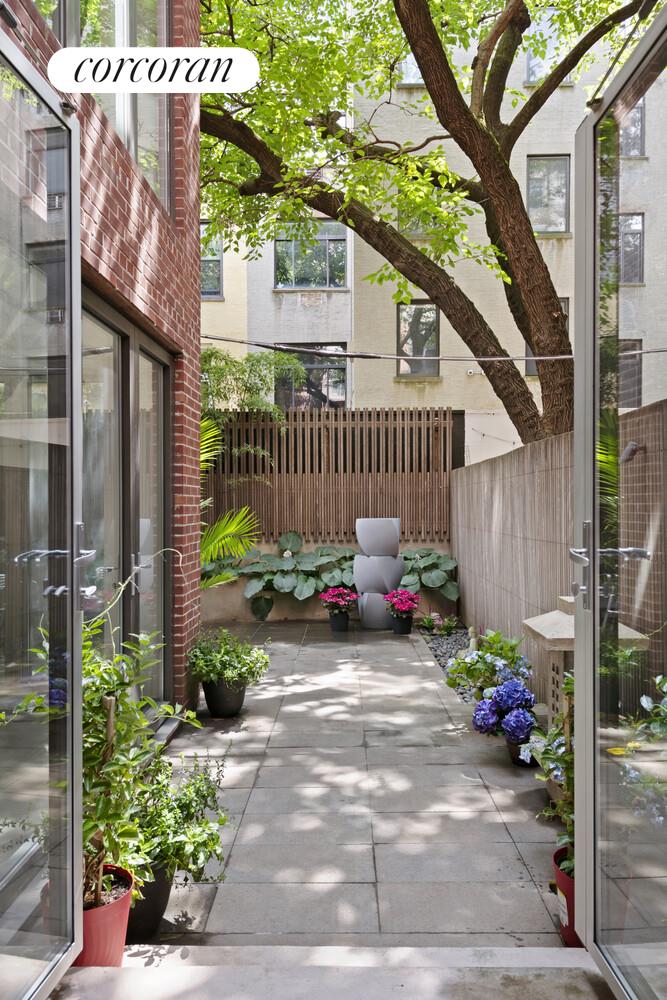 56 West 71st Street, Unit 2A Manhattan, NY 10023 - Photo 14 of 17 a view of a chair and table in the patio with potted plants