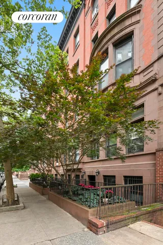 a front view of a building with a garden