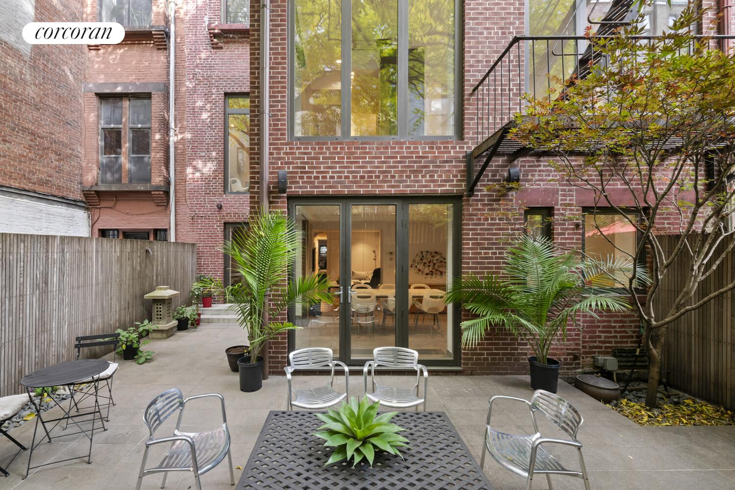 a view of an outdoor sitting area with a table and chairs