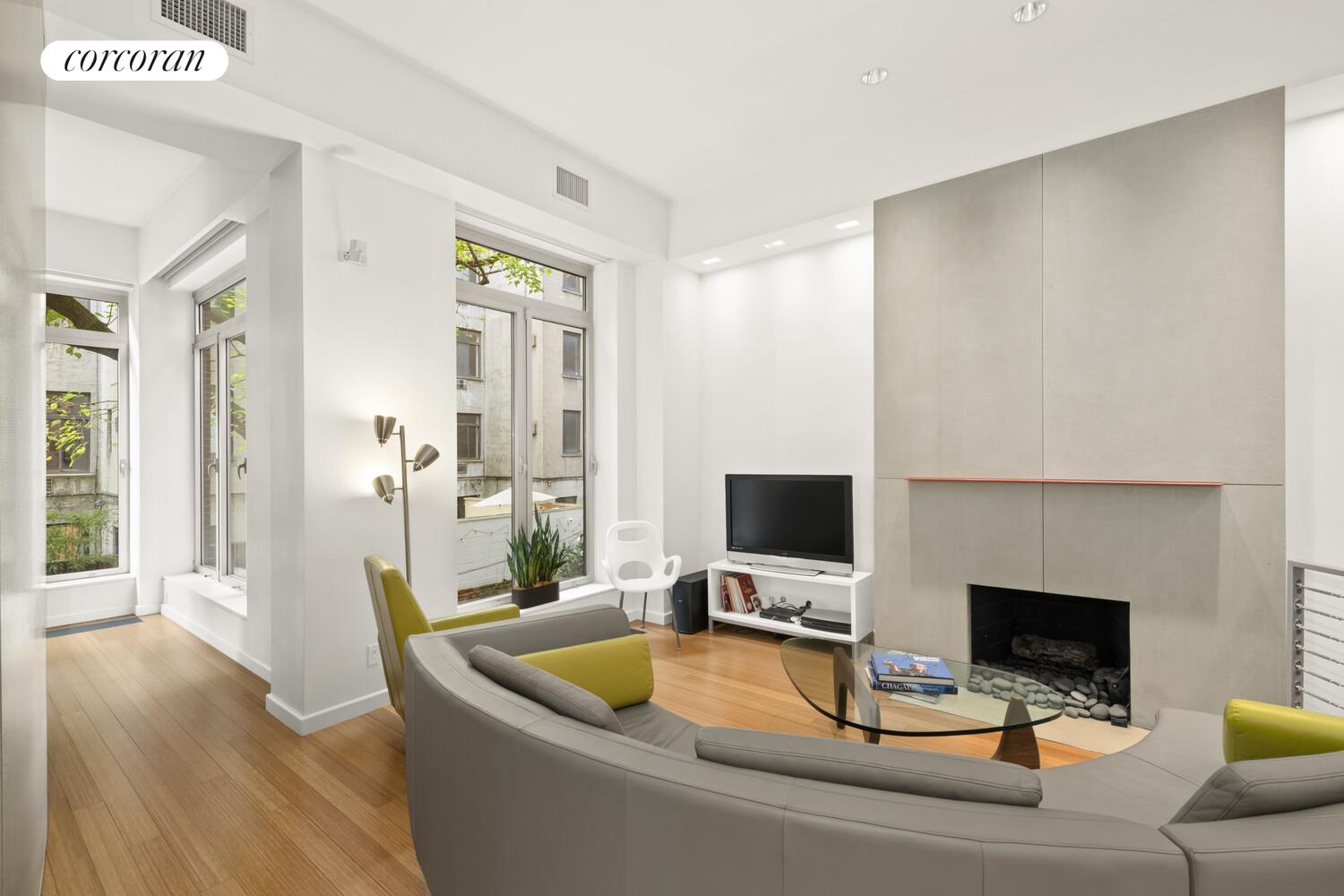 56 West 71st Street, Unit 2A Manhattan, NY 10023 - Photo 2 of 17 a view of a livingroom with workspace and a fireplace