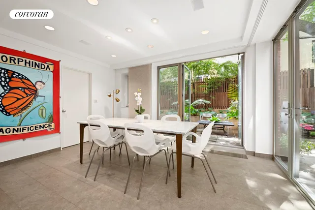a view of a patio with couple of chairs and a potted plant