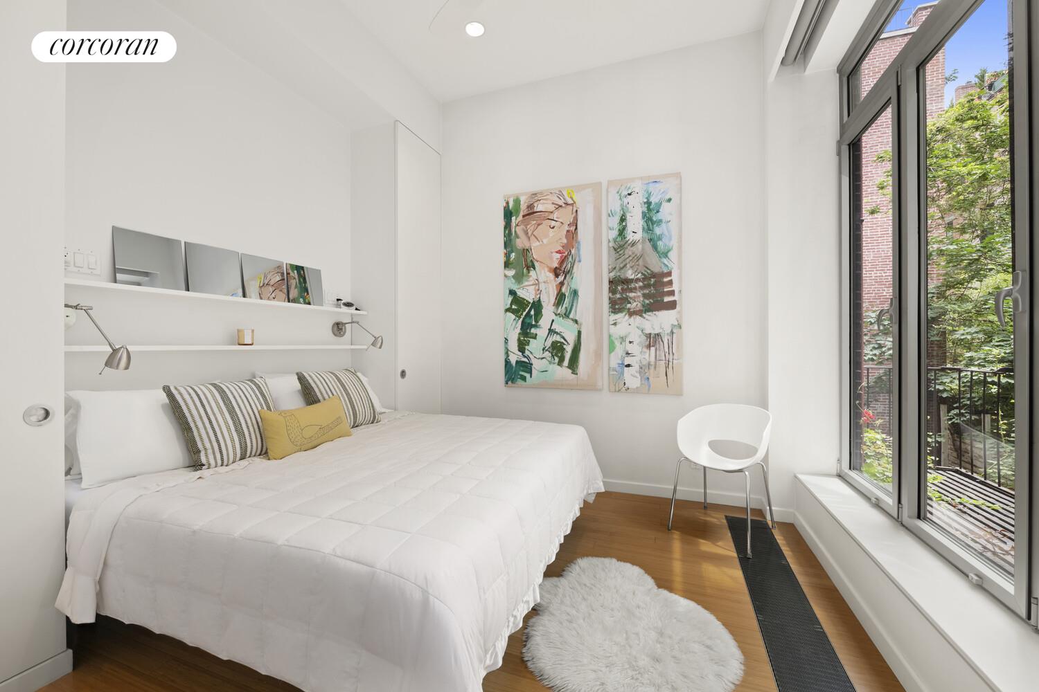 56 West 71st Street, Unit 2A Manhattan, NY 10023 - Photo 6 of 17 a bedroom with a bed and a large window