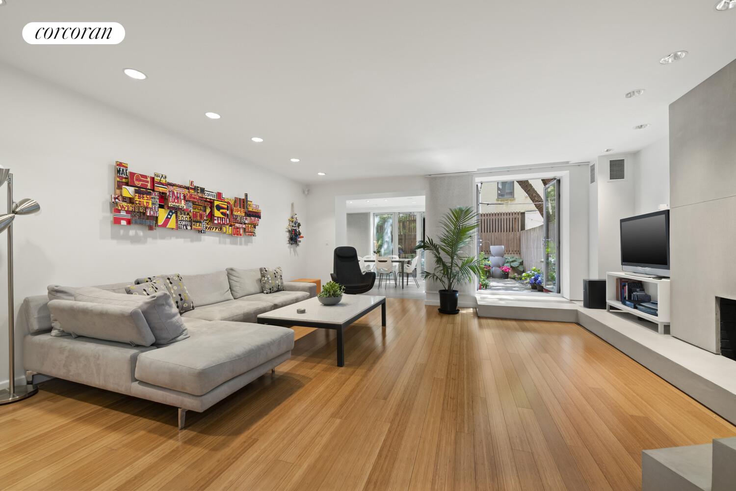 56 West 71st Street, Unit 2A Manhattan, NY 10023 - Photo 7 of 17 a living room with furniture and a flat screen tv