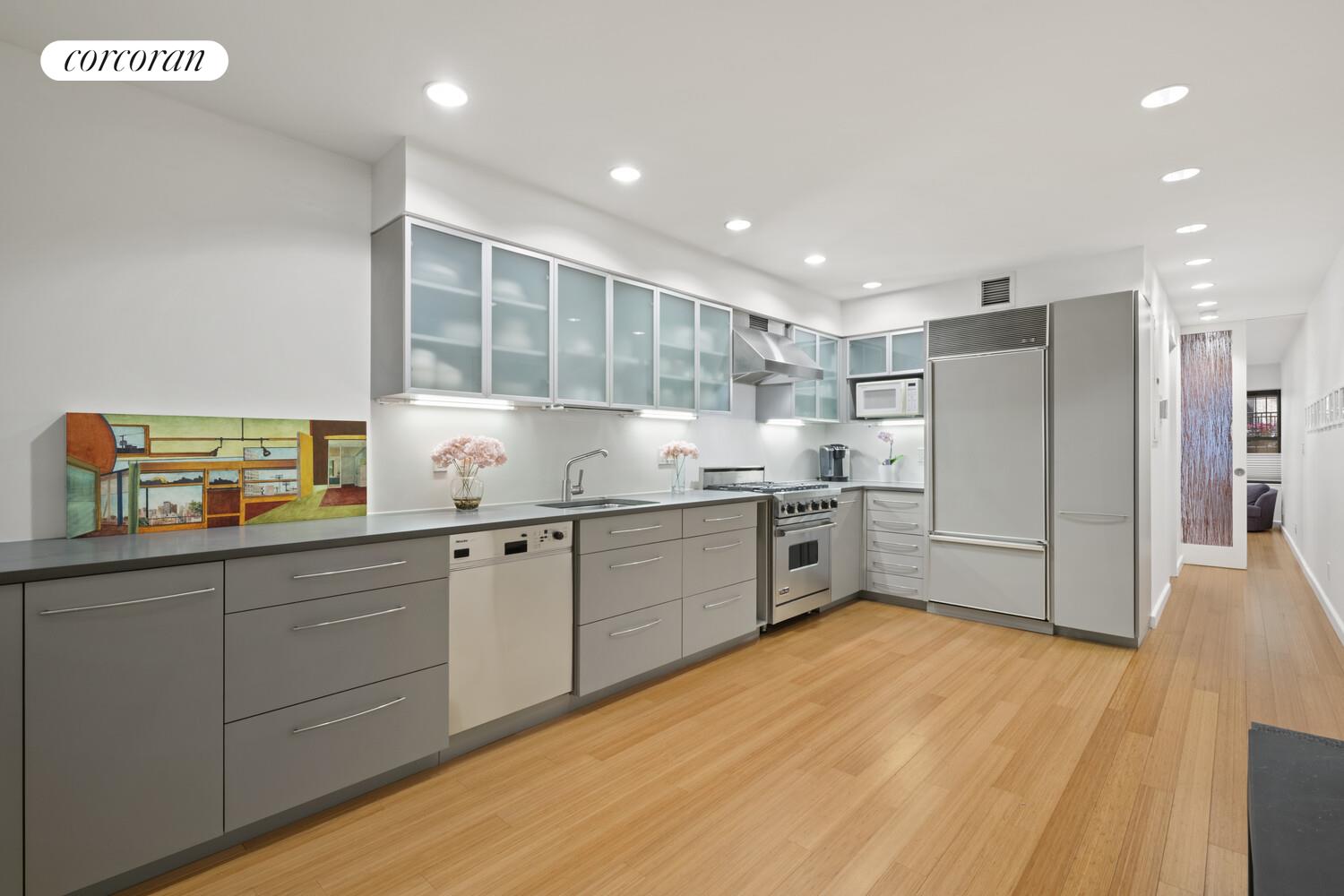 56 West 71st Street, Unit 2A Manhattan, NY 10023 - Photo 8 of 17 a kitchen with granite countertop a sink stainless steel appliances and counter space