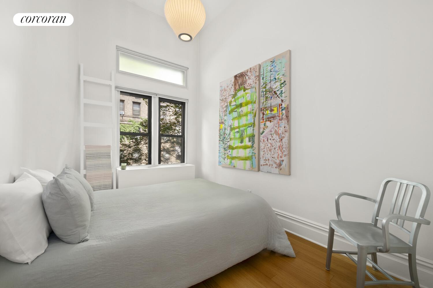 56 West 71st Street, Unit 2A Manhattan, NY 10023 - Photo 9 of 17 a bedroom with a bed and a chair