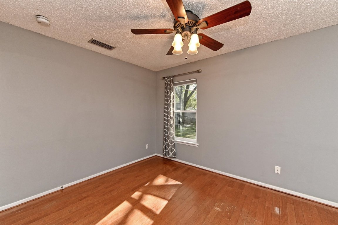 5205 Brookdale Lane Austin, TX 78723 - Photo 12 of 22 an empty room with a window and a fan