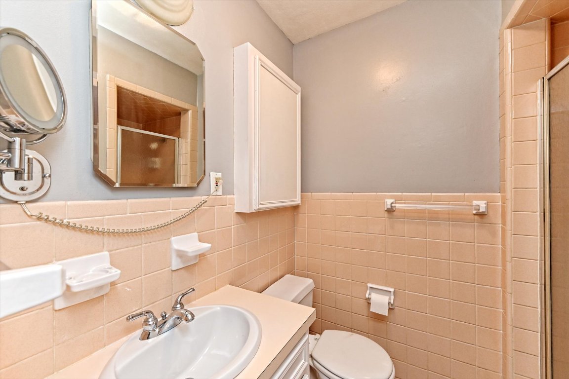 5205 Brookdale Lane Austin, TX 78723 - Photo 14 of 22 a bathroom with a sink mirror vanity and toilet