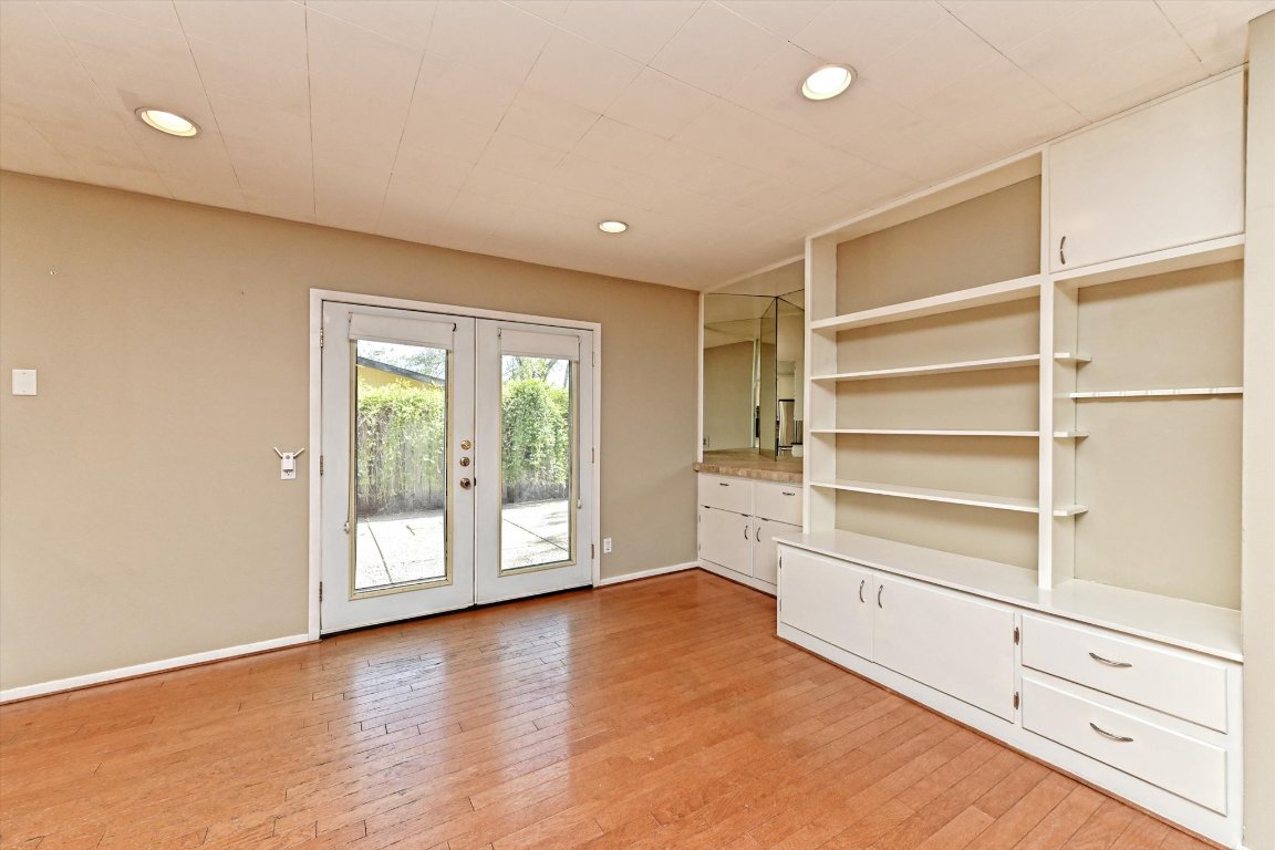 5205 Brookdale Lane Austin, TX 78723 - Photo 4 of 22 a view of an empty room with a window and wooden floor