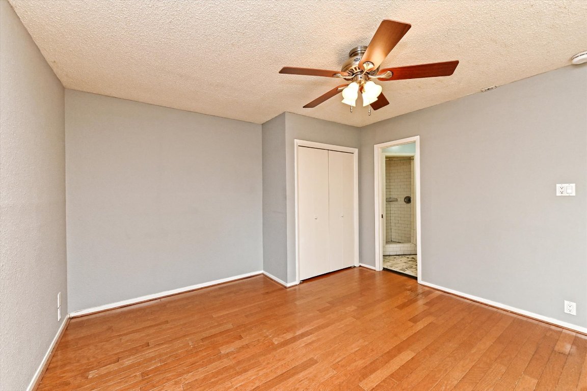 5205 Brookdale Lane Austin, TX 78723 - Photo 10 of 22 a view of a room with a ceiling fan and wooden floor