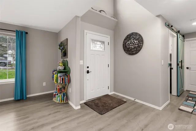 an empty room with wooden floor and a window