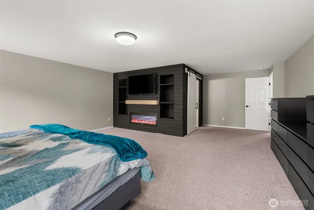 a bedroom with a bed and a television in it