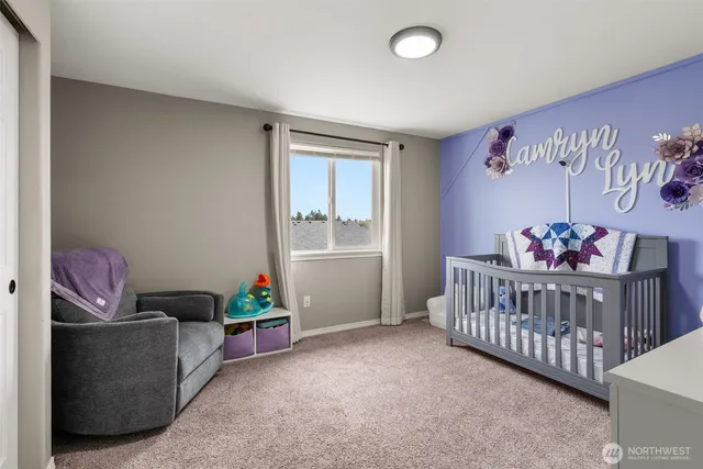 a bedroom with furniture and baby crib