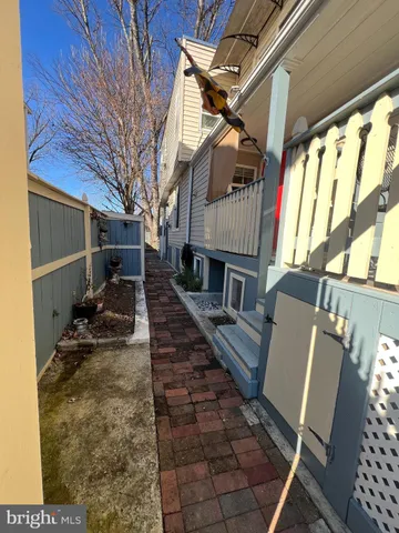 a view of a chairs and table in the back yard of the house