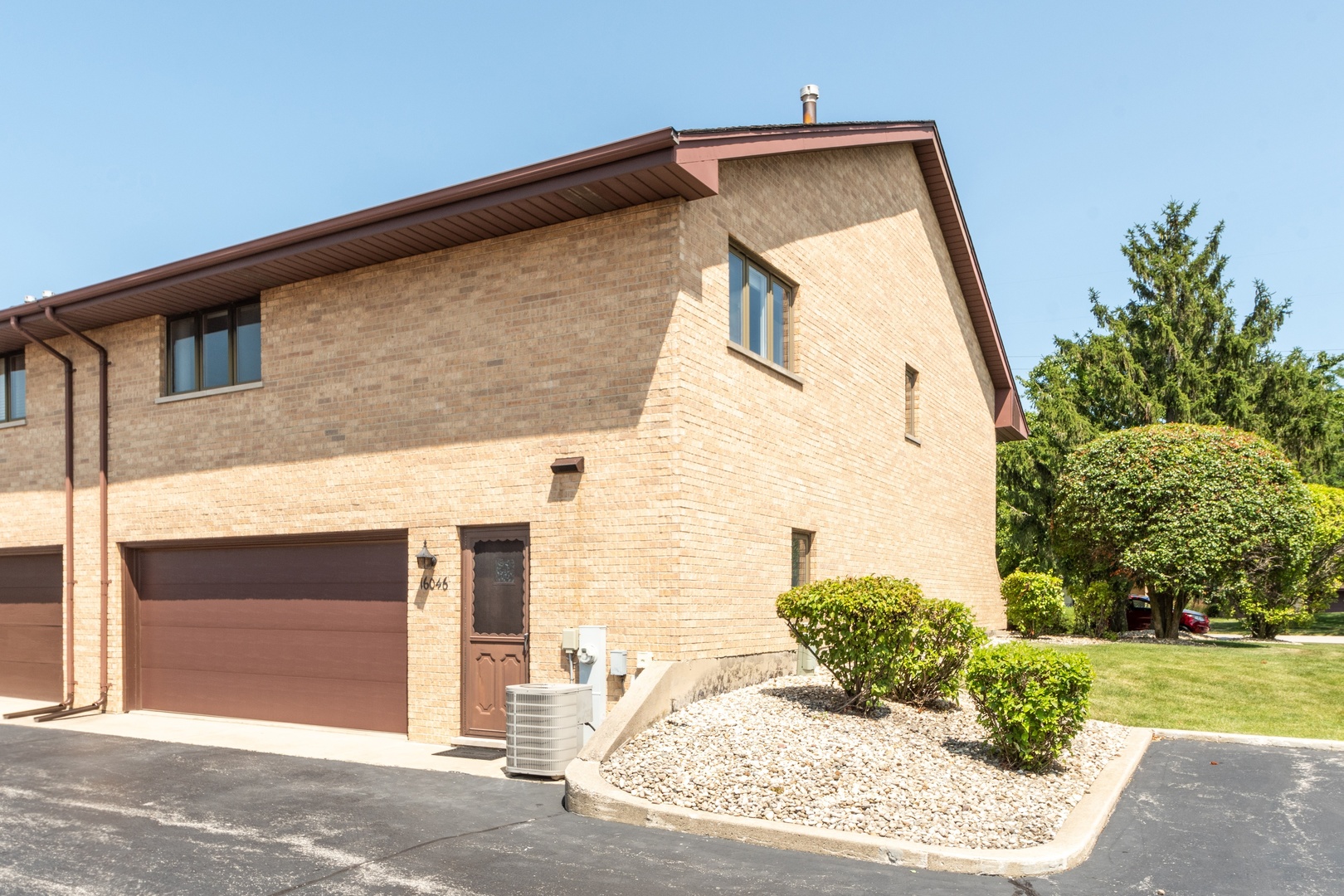 16046 Eagle Ridge Drive Tinley Park, IL 60477 - Photo 14 of 14 a front view of a house with garden