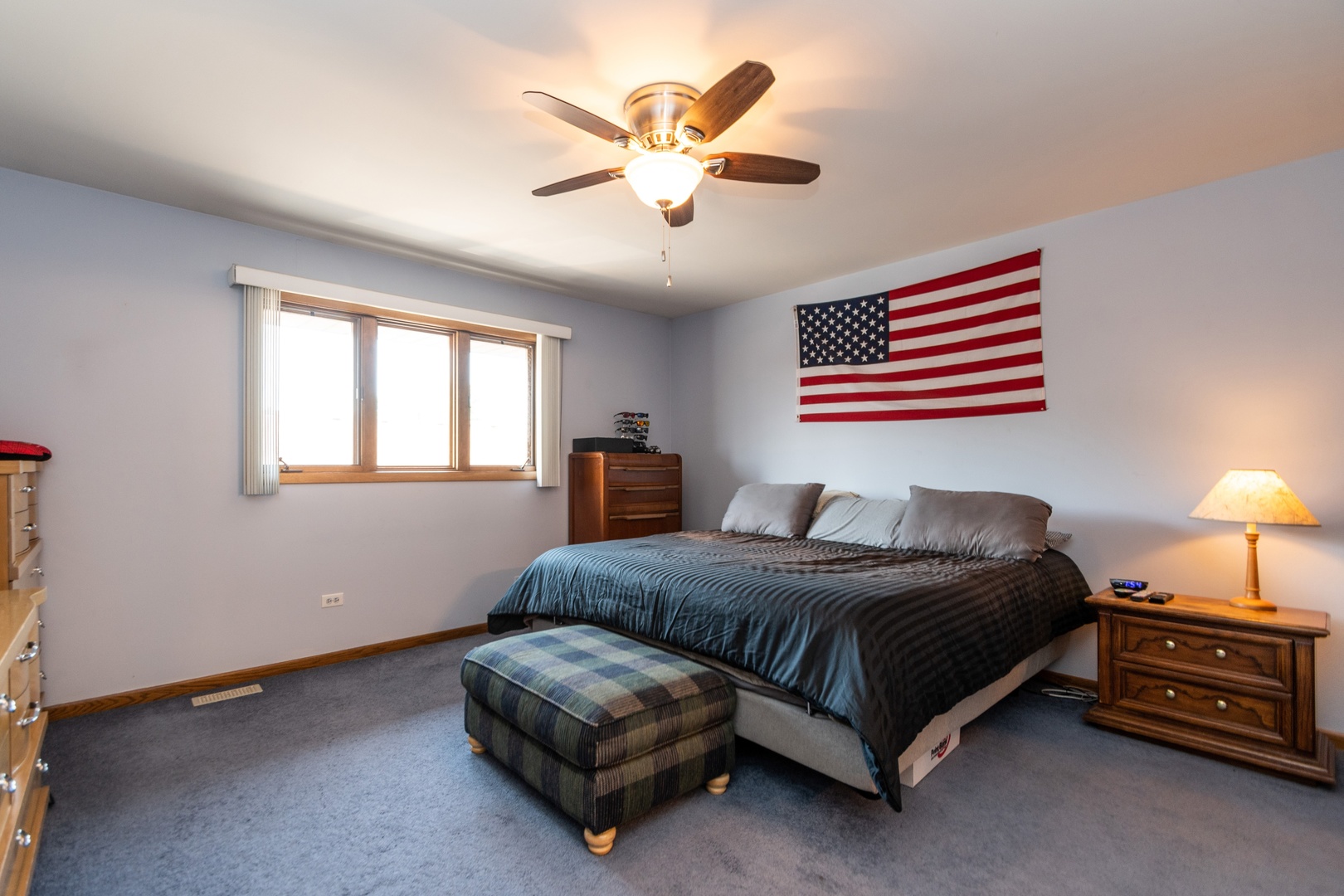 16046 Eagle Ridge Drive Tinley Park, IL 60477 - Photo 8 of 14 a bedroom with a bed and a chandelier
