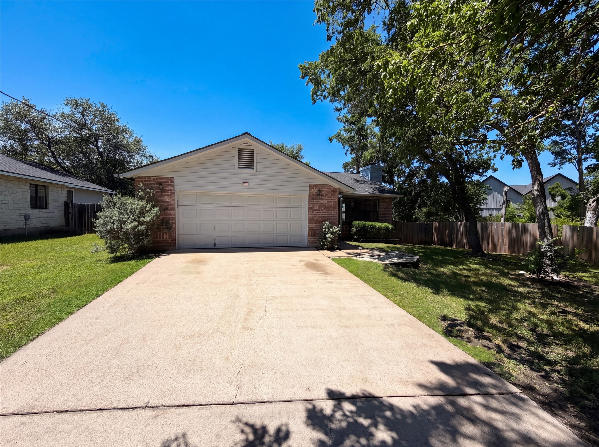 1111 North Riviera Circle Cedar Park, TX 78613 - Photo 15 of 17 Single-story residence featuring a brick and siding exterior, an attached two-car garage, and a concrete driveway