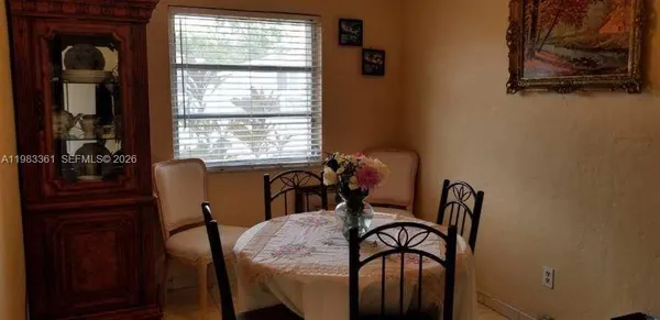 a view of a dining room with furniture and window