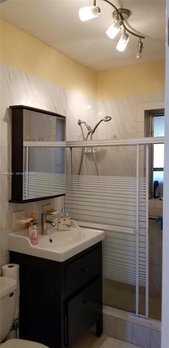 2787 Southwest 34th Court Miami, FL 33133 - Photo 12 of 15 a bathroom with a sink and a mirror