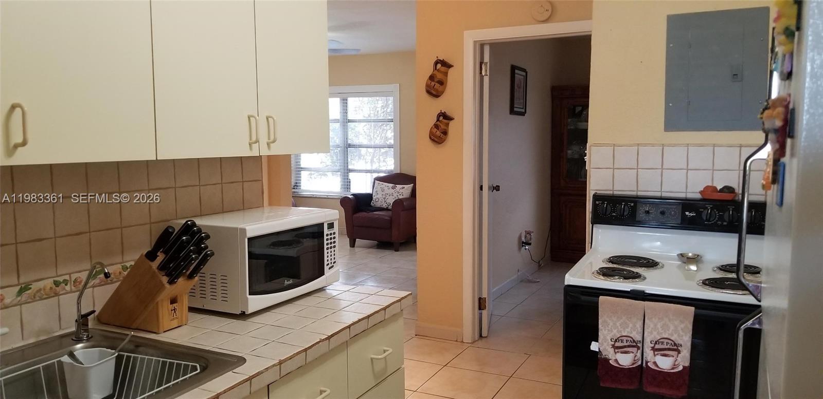 2787 Southwest 34th Court Miami, FL 33133 - Photo 10 of 15 a kitchen with a stove and a microwave