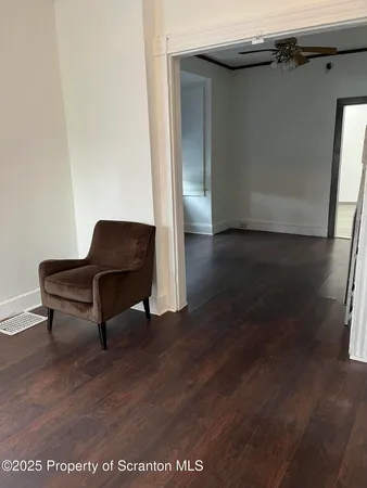 a living room with wooden floor and furniture