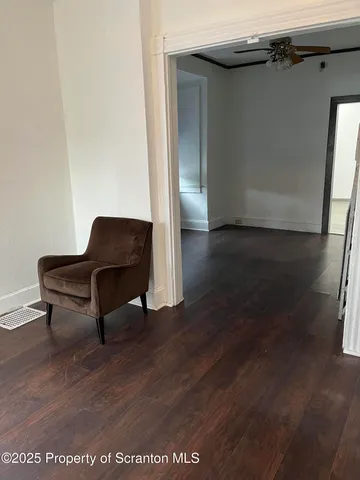 a living room with wooden floor and furniture