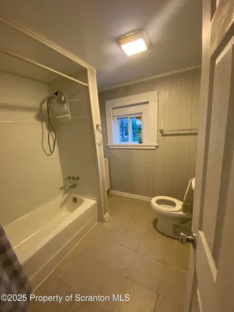 a bathroom with a tub and a shower