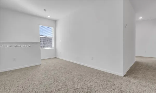 a bathroom with a granite countertop sink and a toilet