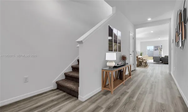 a living room with furniture dining table and a wooden floor