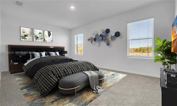 a bedroom with a bed and painting on the wall