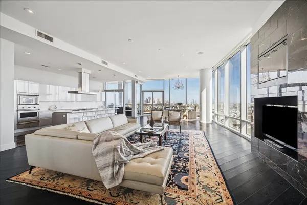 a living room with furniture wooden floor and a flat screen tv
