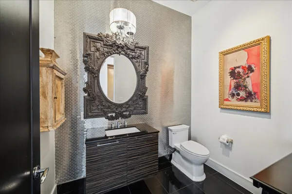 a bathroom with a toilet a sink and mirror