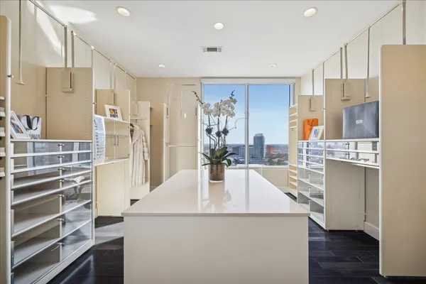 a kitchen with kitchen island a stove a refrigerator and a sink with wooden floor