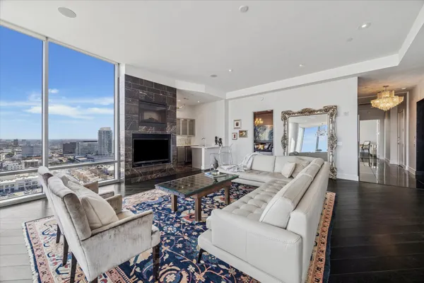 a living room with furniture wooden floor and a fireplace