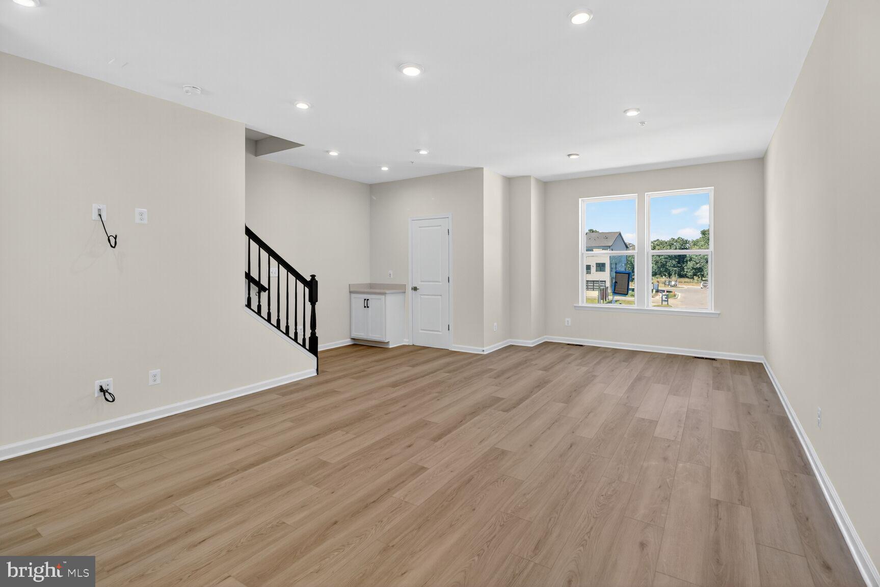 1815 John Stricker Avenue Baltimore, MD 21222 - Photo 6 of 46 an empty room with wooden floor and windows